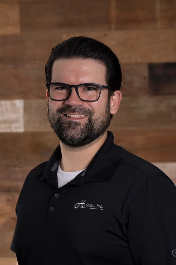 Zach Wood, Estimator II at Holman, Inc., in a formal headshot.