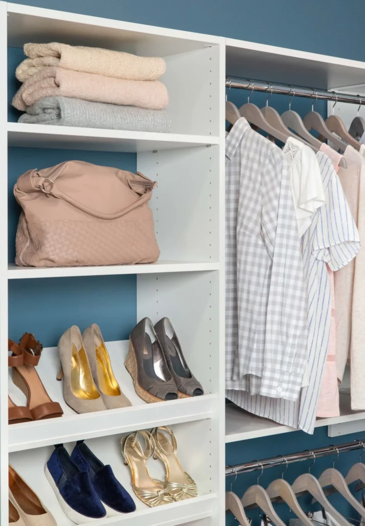 select white walk-in closet with corner rod