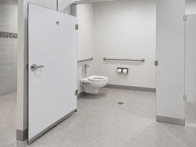 ada-toilet-compartment-door-swing - Holman, Inc. Open ADA toilet compartment door showing clear floor space and turning area